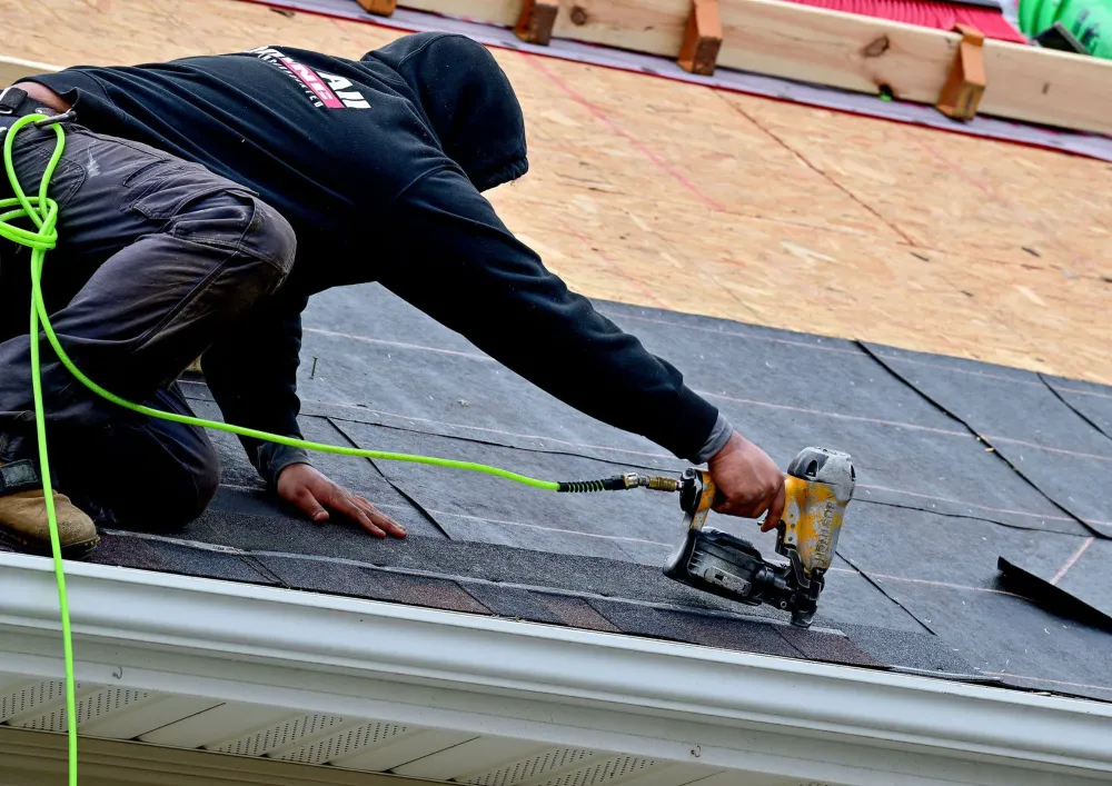 Professional roofer conducting emergency roof repairs after heavy storm damage in Rochester, Minnesota
