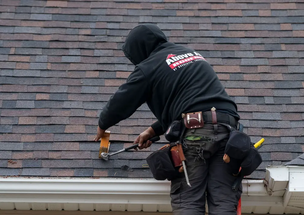 Skilled roofer repairing cracked and missing shingles to restore roof integrity