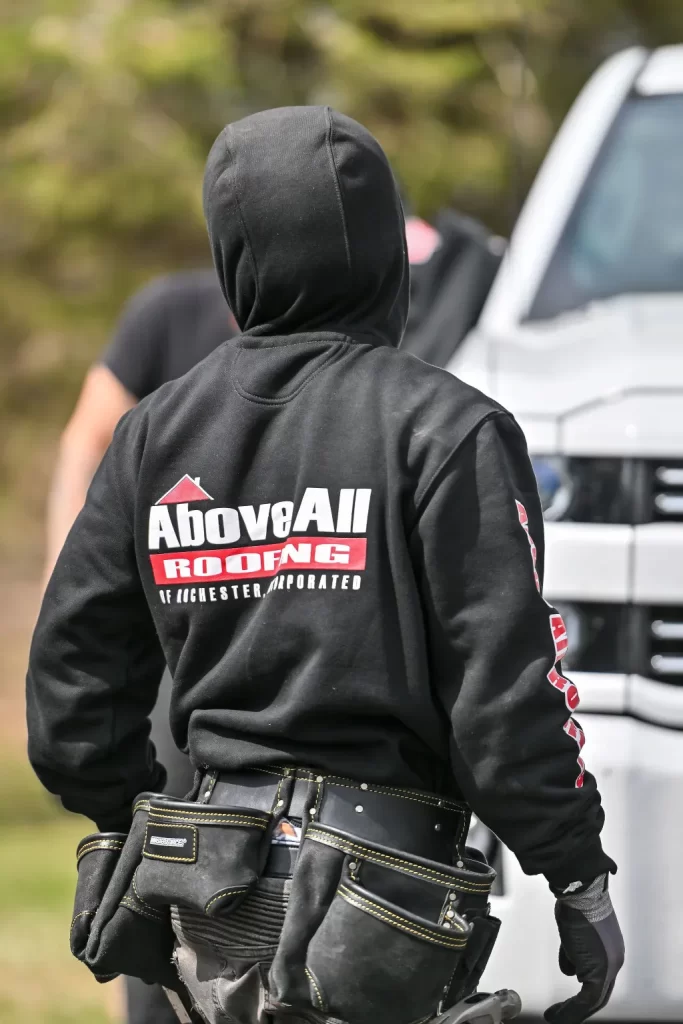 Roofer assessing and repairing structural damage on a residential roof in Rochester, Minnesota