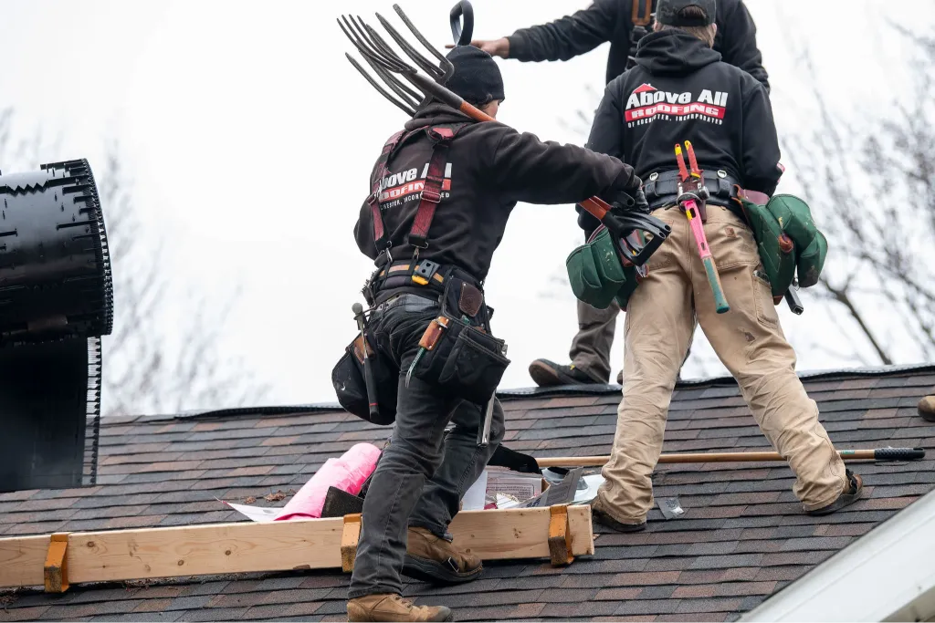 Roofing professional sealing a roof leak on a Rochester home to prevent interior damage