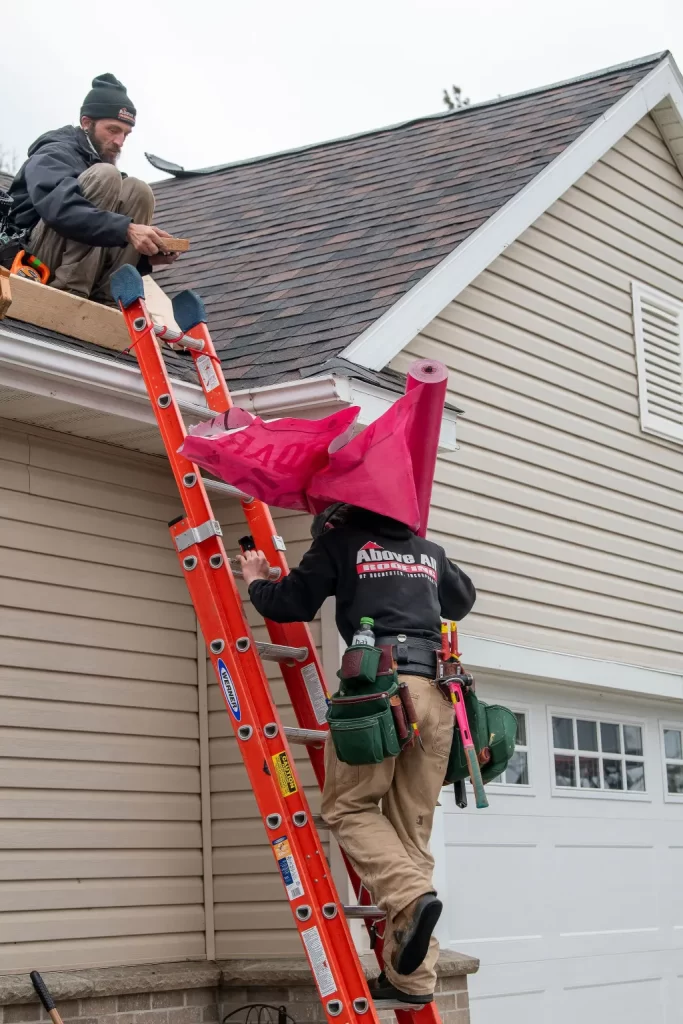 Above All Roofing technician inspecting roof flashing and sealing vulnerable areas