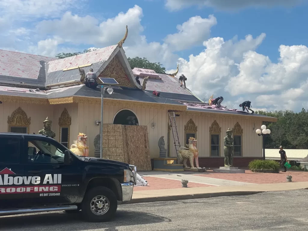 Roofers from Above All Roofing maintaining the roof of a Rochester church with care and precision