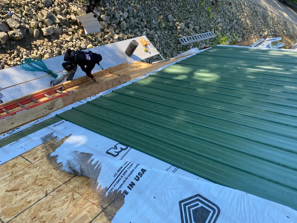 Above All Roofing professionals installing high-quality metal roofing on a residential property