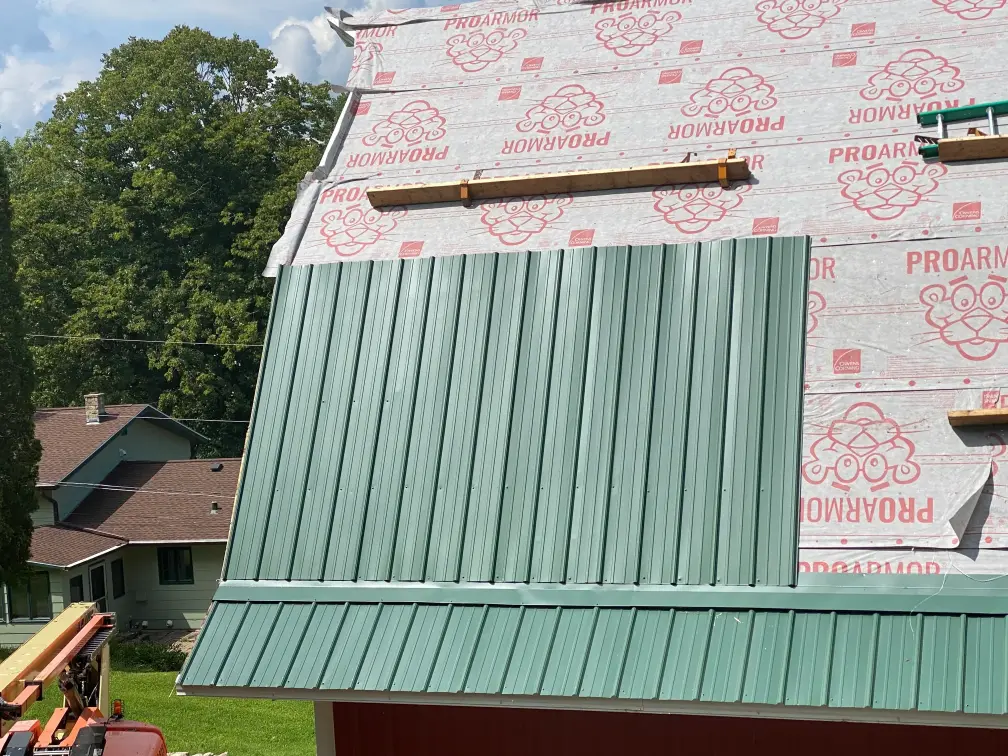 Close-up of premium metal roofing panels with protective coating being installed