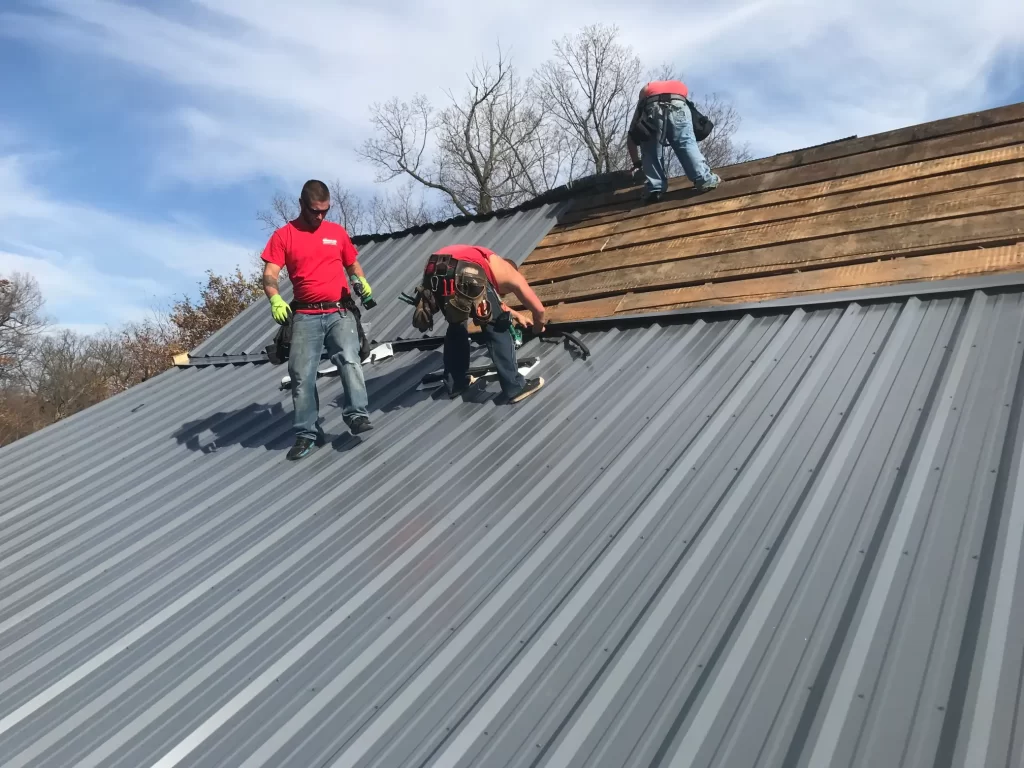 Above All Roofing team completing a high-end metal roof on a suburban Minnesota home