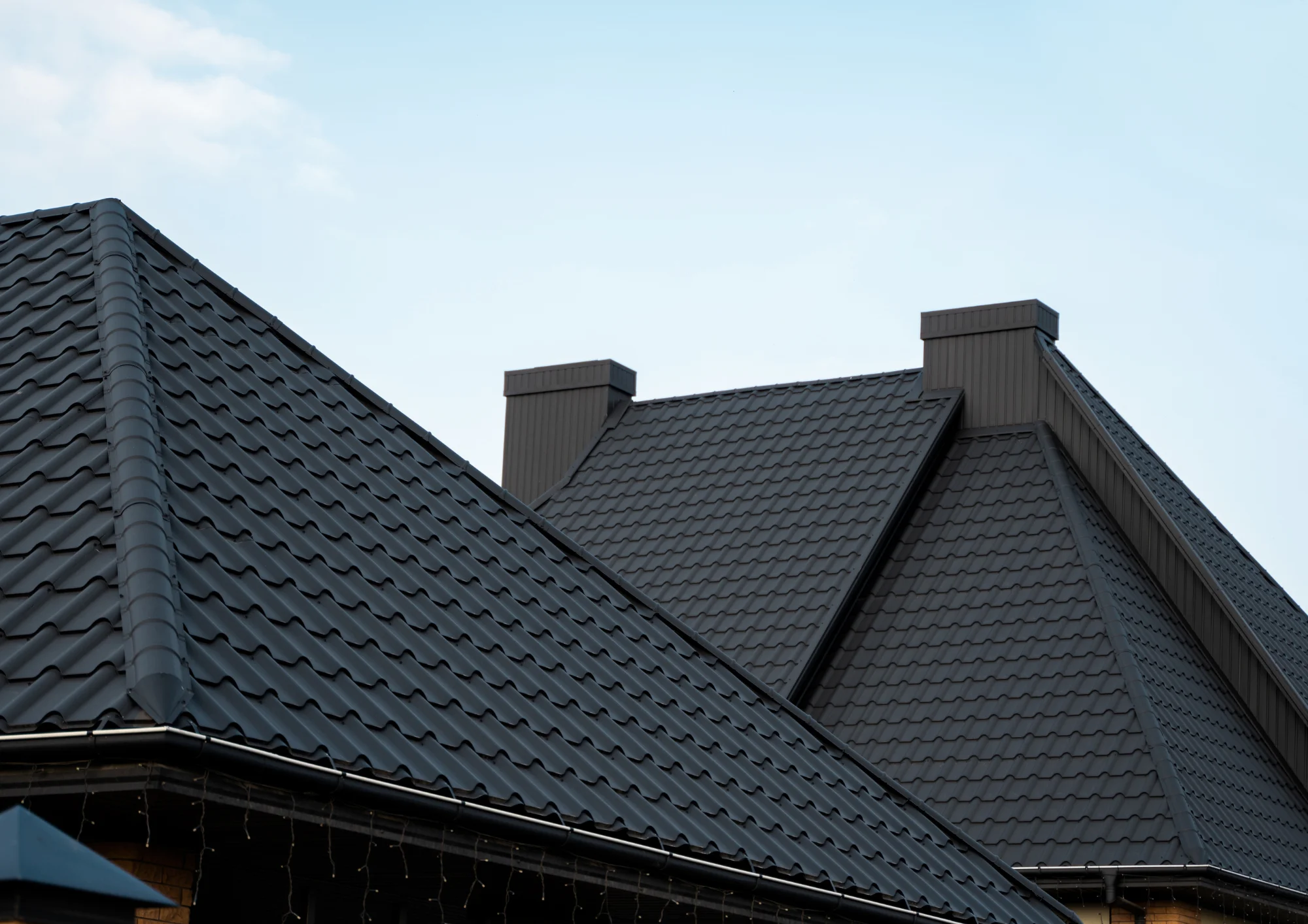Durable black metal roof on a home built for harsh Minnesota weather by Above All Roofing