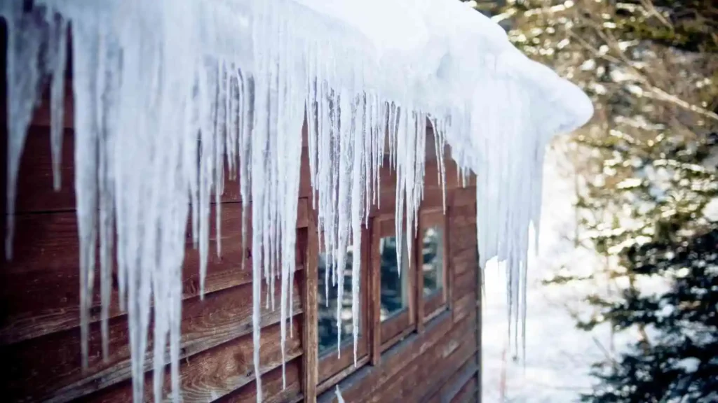 Metal roof shedding snow, showing durability in harsh winter conditions